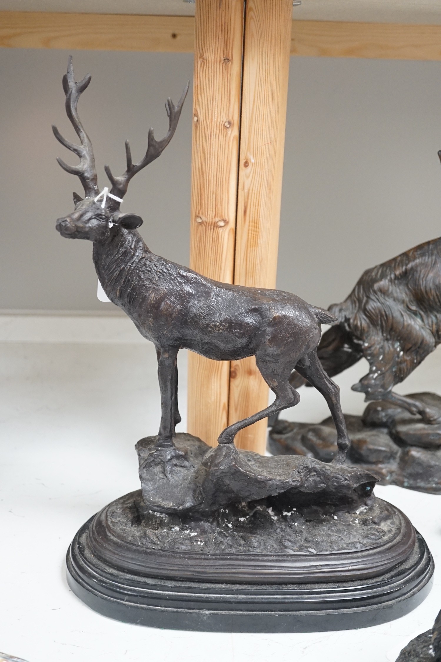 Four bronze animal groups, three foxes, a ram, a stag and two dogs, tallest stag 40.5 cms high